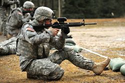 Soldier firing M4 rifle