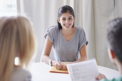 Young woman being interviewed by two managers