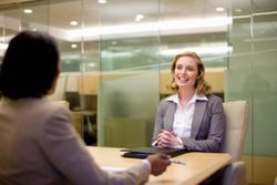 Woman answering leadership questions in a job interview.