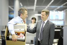 Fired male worker with a box of personal items