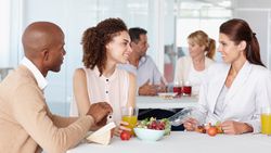 Black and white HR recruiters are welcoming new employee to her new job.