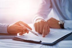 Two men reviewing a legal writing sample.