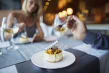 Couple eating dessert in fancy restaurant