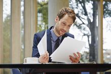 Businessman reading documents at desk