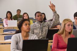 Soldier in a college classroom using the military college loan and repayment program