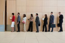 a group of business professionals standing in line