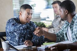 Military recruiter meeting with young man at military recruitment event