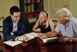 Senior couple looking over documents with financial advisor