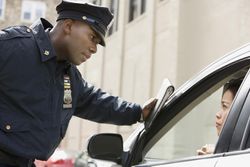 African policeman giving woman ticket