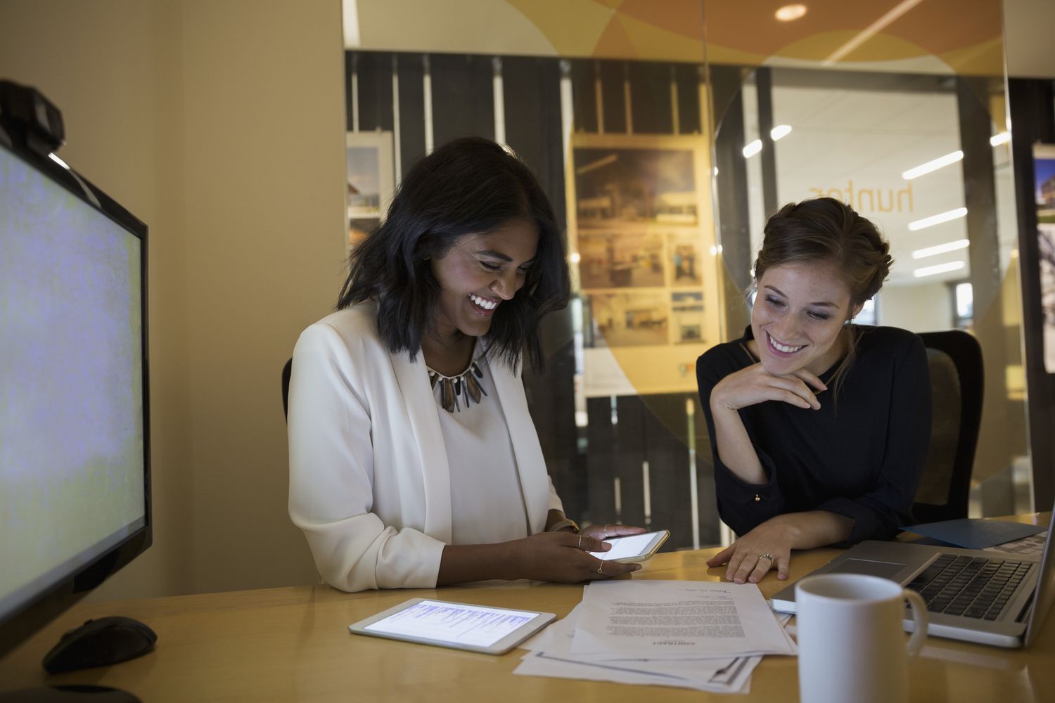 Two coworkers writing a reference letter for an employee