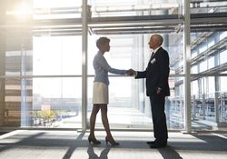 Young Woman Shaking Hands With a Mature Man