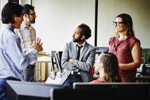 Coworkers collaborate on a project in an office