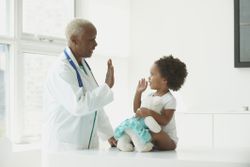 doctor high fives patient