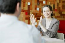 Mid adult businesswoman explaining in meeting