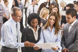 Employee shares her award letter with her colleagues.