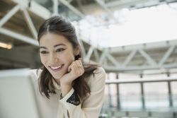 woman smiling while reading email