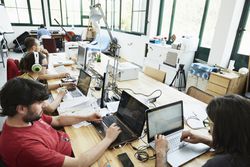 A room of software engineers working on laptops