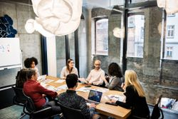 A group of young people in a business meeting