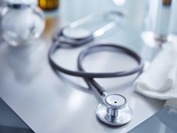 stethoscope on table with other medical items in background