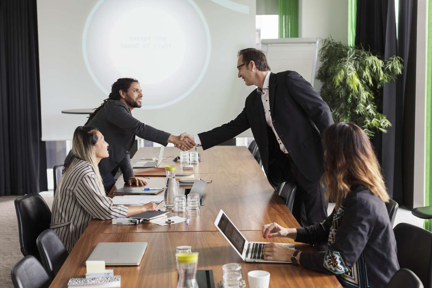 Two men shaking hands at a business meeting