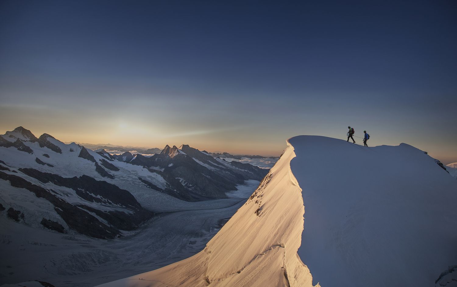 Climbers reaching the top of a mountain