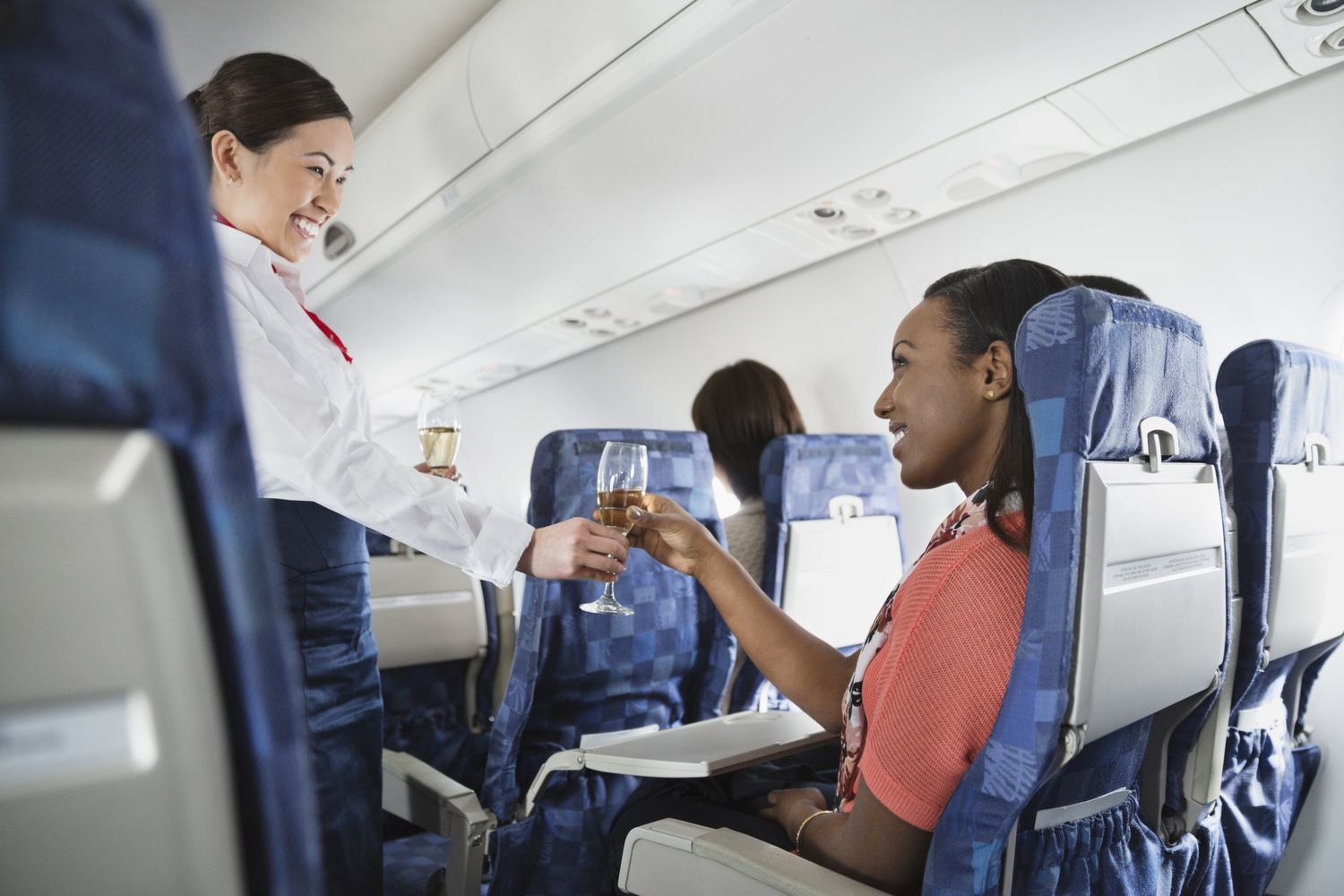 Flight attendant serving a passenger