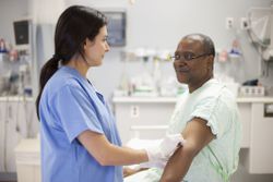 Phlebotomist drawing blood from patient