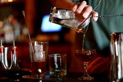 Bartender pouring a cocktail in a bar