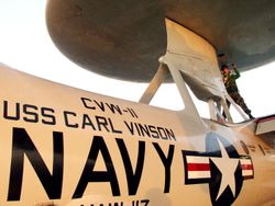 A U.S. Navy Aviation Electronics Technician completes a maintenance check on the radar dome of the E-2C &#39;Hawkeye&#39;