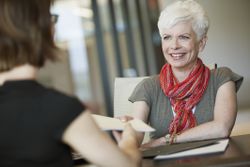 Woman passing piece of paper