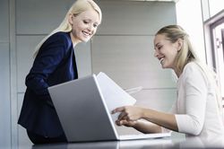 women sharing information at computer