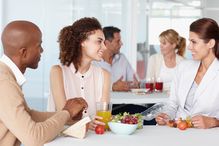 Black and white HR recruiters are welcoming new employee to her new job.