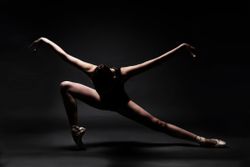 Ballet Dancer Dancing Against Gray Background