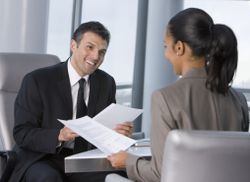 Man and woman dressed in formal business attire collaborate