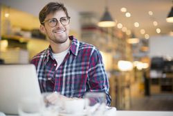 Man using laptop in cafe