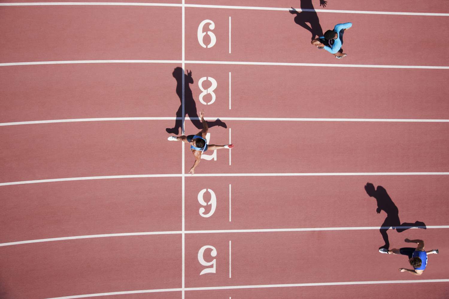 Runner crossing finishing line on track