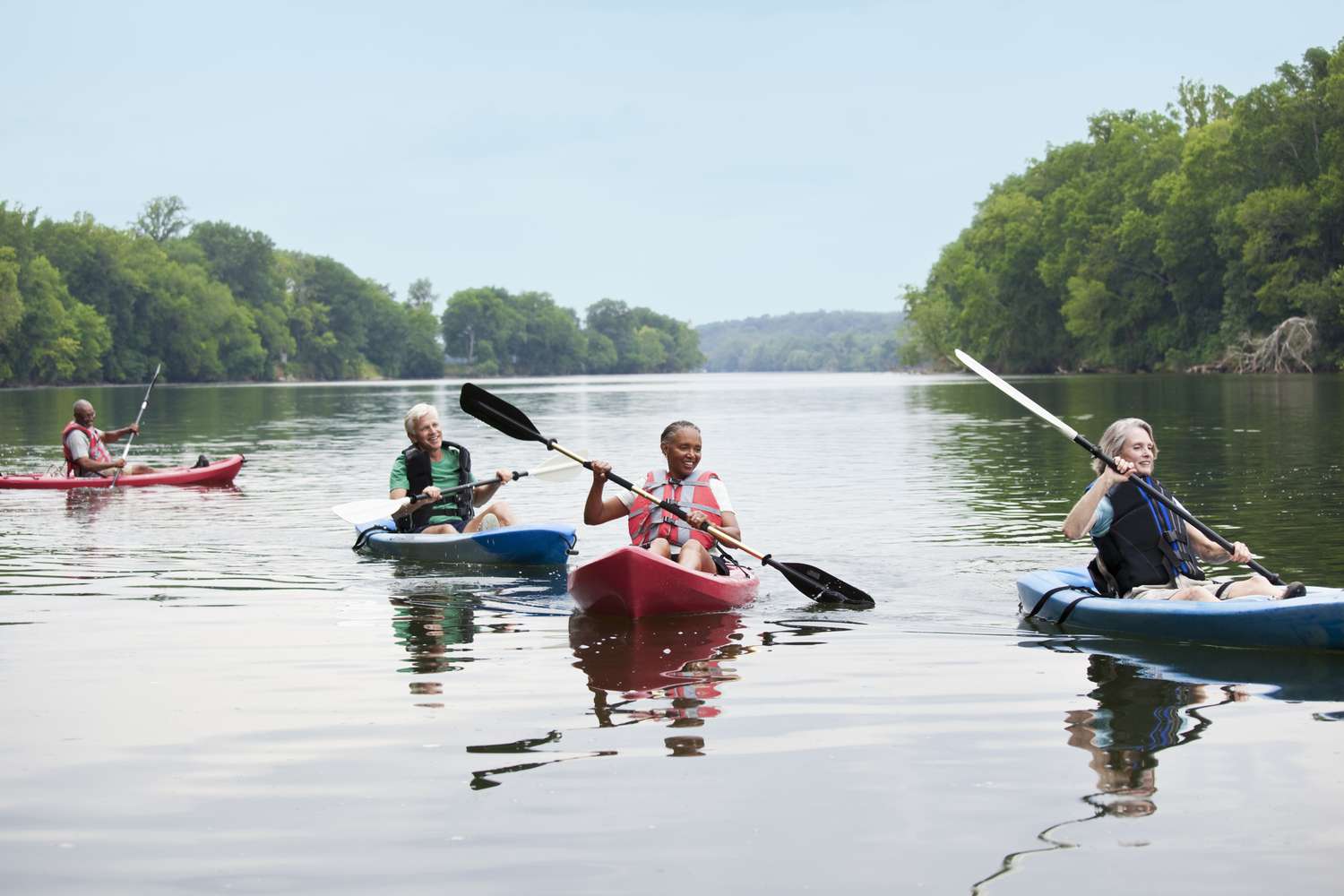 Couples kayaking on river