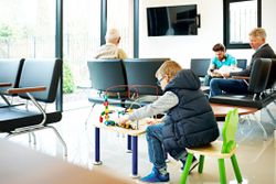 Little boy playing in waiting room at the clinic