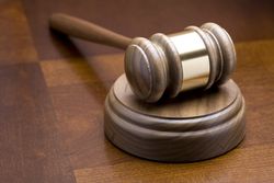 Gavel on a wooden table, representing the work done by legalmen.