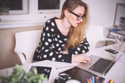 a woman working on a laptop computer