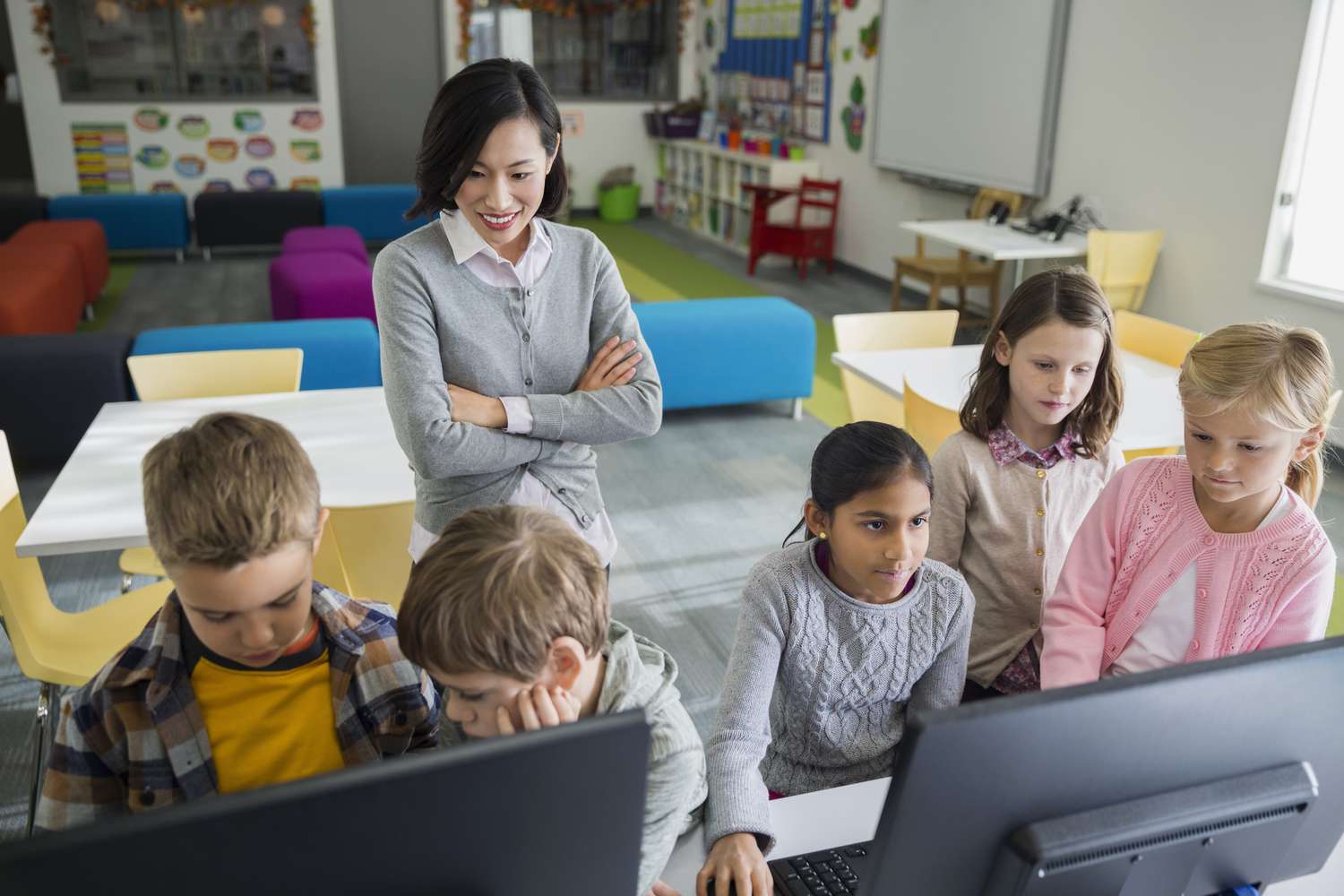 Teacher in classroom with students using computers