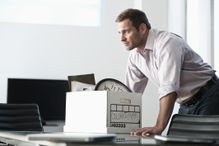 Man with box at desk