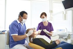 Dentist operating on patient