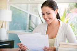 Woman looking over a thank you note from her executive employer.