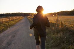 Person stepping toward sunlight