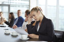 Businesswoman reading bad news at meeting