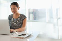 Woman typing at her desk