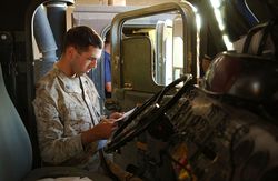 U.S. marine reading letter in truck cab