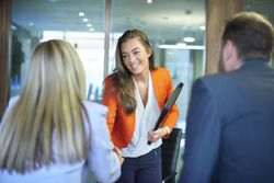 a young woman meeting with business professionals