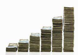 stacks of money representing increased broker commission